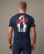 Man from behind in studio wearing navy t-shirt featuring "We're Still Heading Up" firefighter back graphic.