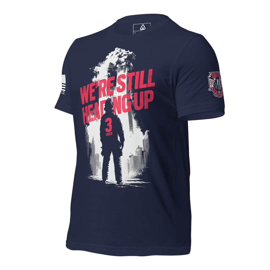 Navy t-shirt, three-quarter view angled left, firefighter graphic, American flag right sleeve, 3 Truck crest left sleeve.