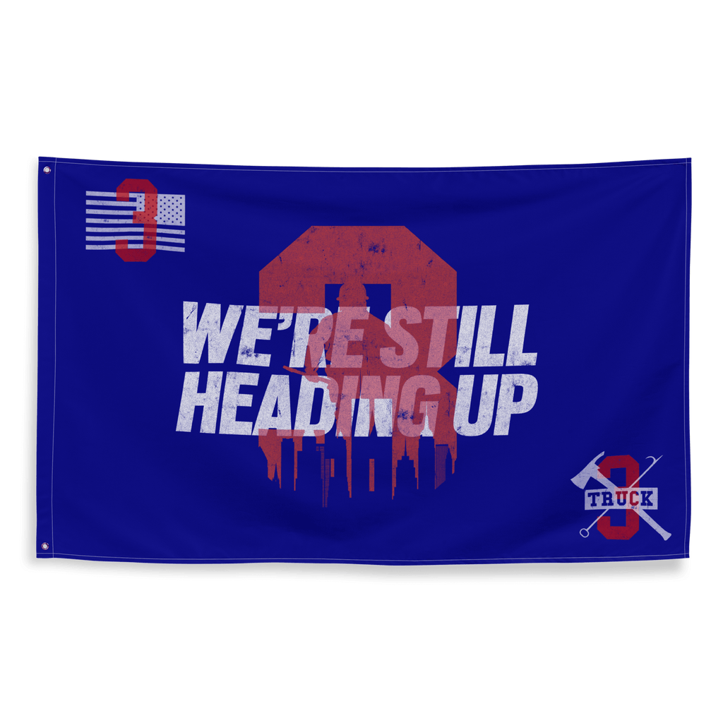 Blue flag featuring a red distressed number 3 with a city skyline and crossed firefighting tools on the corners.