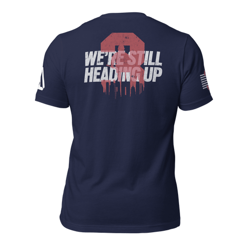 Back of blue T-Shirt with a red dripping "3" over a white city skyline and "WE'RE STILL HEADING UP".