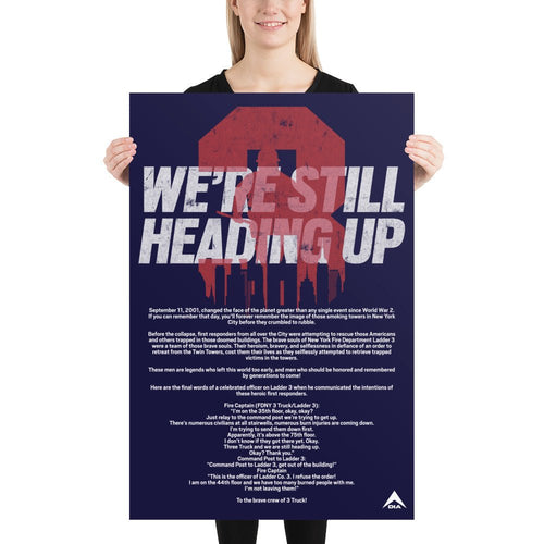 Woman holding a navy blue poster featuring "WE'RE STILL HEADING UP" text, a red 3 graphic, and a small DIA logo.