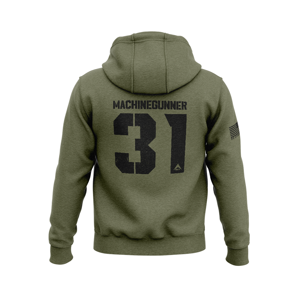 Military green hoodie with back "MACHINEGUNNER 31" graphic, DIA logo, and an American flag patch on the right sleeve.