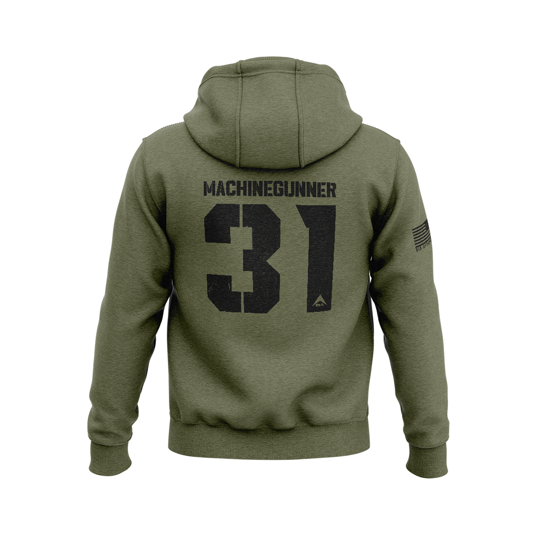 Military green hoodie with back "MACHINEGUNNER 31" graphic, DIA logo, and an American flag patch on the right sleeve.