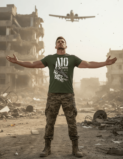 A man in a green "A10 WARTHOG BRRRT!" t-shirt stands in a war-torn city with an A-10 jet flying overhead.