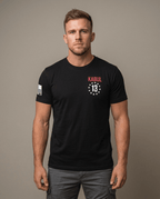 Man in studio wearing a black T-shirt featuring the Kabul 13 chest emblem and American flag sleeve patch.