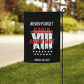 Black garden flag on a lawn with barbed wire, XIII roman numeral, 13 stars, "KABUL", "ABBEY GATE", and "AUGUST 26, 2021".