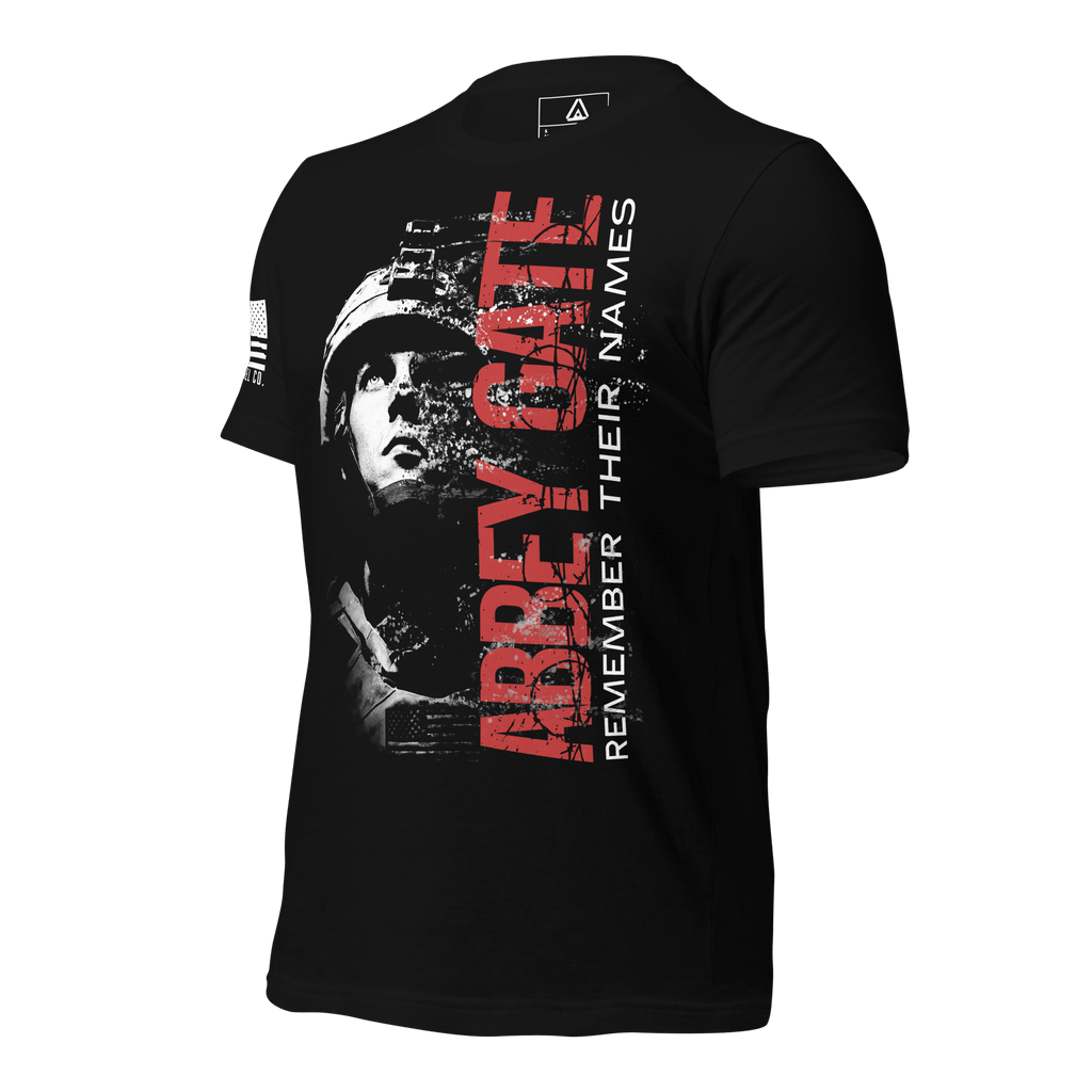 Black t-shirt, angled, showing red "ABBEY GATE REMEMBER THEIR NAMES", soldier graphic, and US flag on the sleeve.