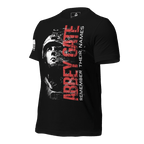 Black t-shirt, angled, showing red "ABBEY GATE REMEMBER THEIR NAMES", soldier graphic, and US flag on the sleeve.
