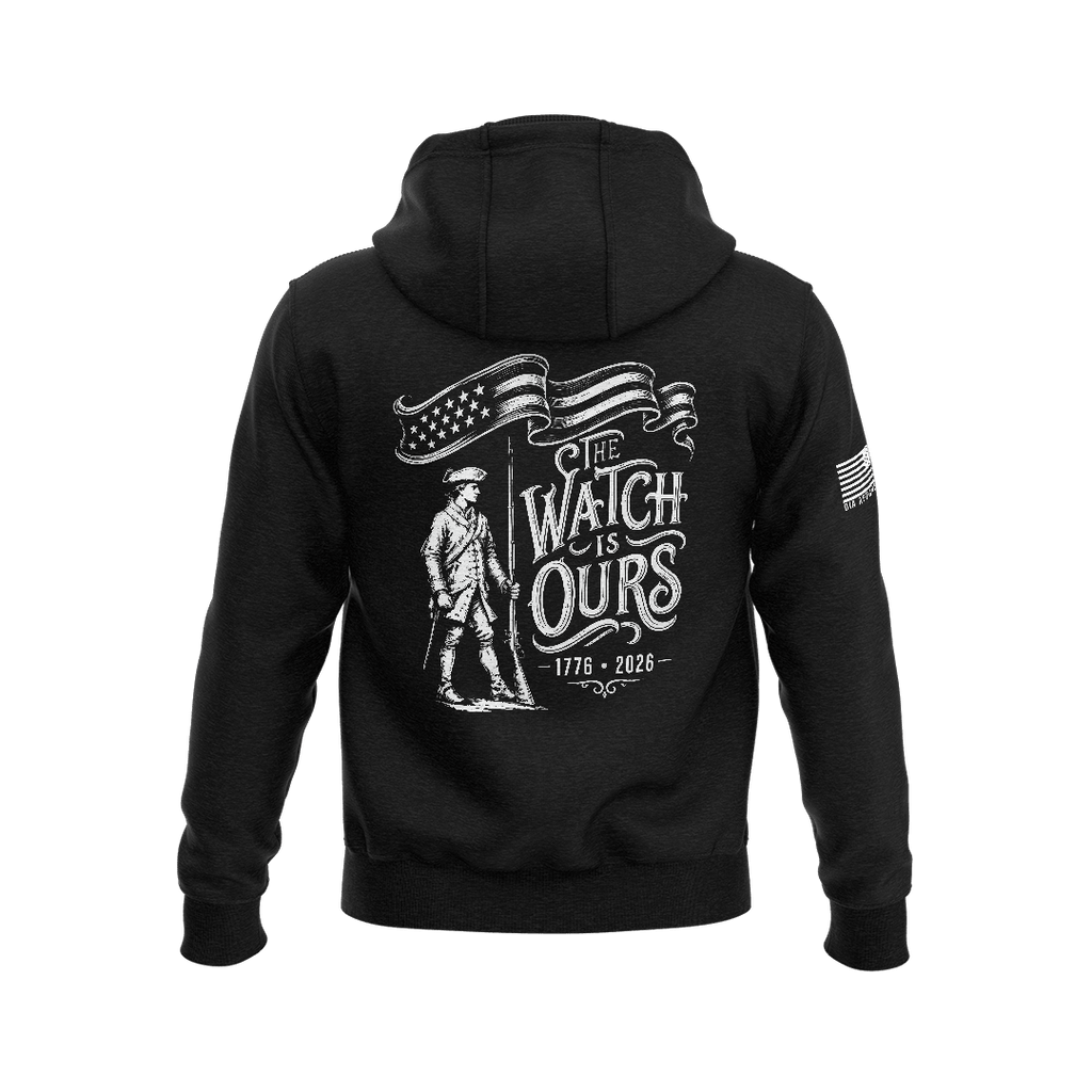 Black hoodie featuring back graphic with a Minute Man soldier, "THE WATCH IS OURS 1776-2026" text, and American flag sleeve patch.
