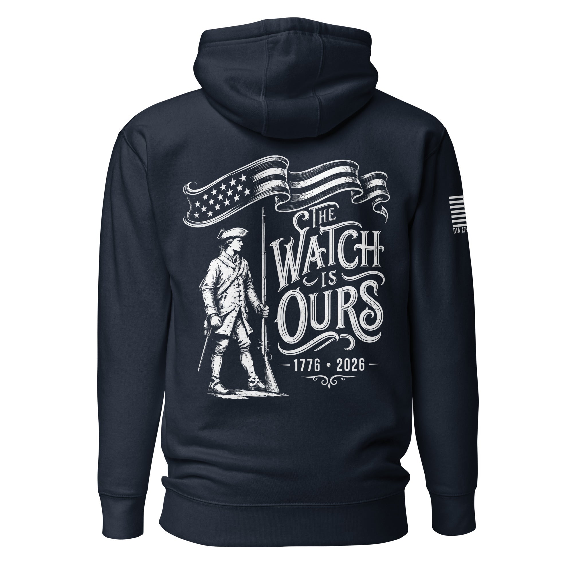 Navy hoodie with "THE WATCH IS OURS 1776-2026" minuteman back graphic and American flag sleeve patch.