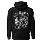 Black hoodie with "THE WATCH IS OURS 1776-2026" minuteman back graphic and American flag patch on sleeves.