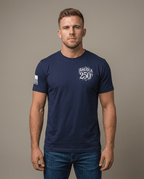 Man in studio wearing navy t-shirt featuring "AMERICA 250TH" chest graphic and American flag sleeve patch.