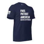 Navy blue t-shirt angled left, with "FREE PATRIOT AMERICAN" text and a white American flag on the right sleeve.
