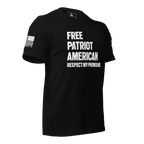 Black t-shirt shown from a three-quarter view angled left, featuring white text and a white American flag on the sleeve.