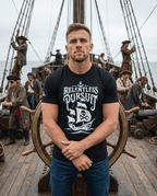Man standing on a ship deck with a crew, wearing a black t-shirt with a pirate ship graphic and "RELENTLESS PURSUIT" text.