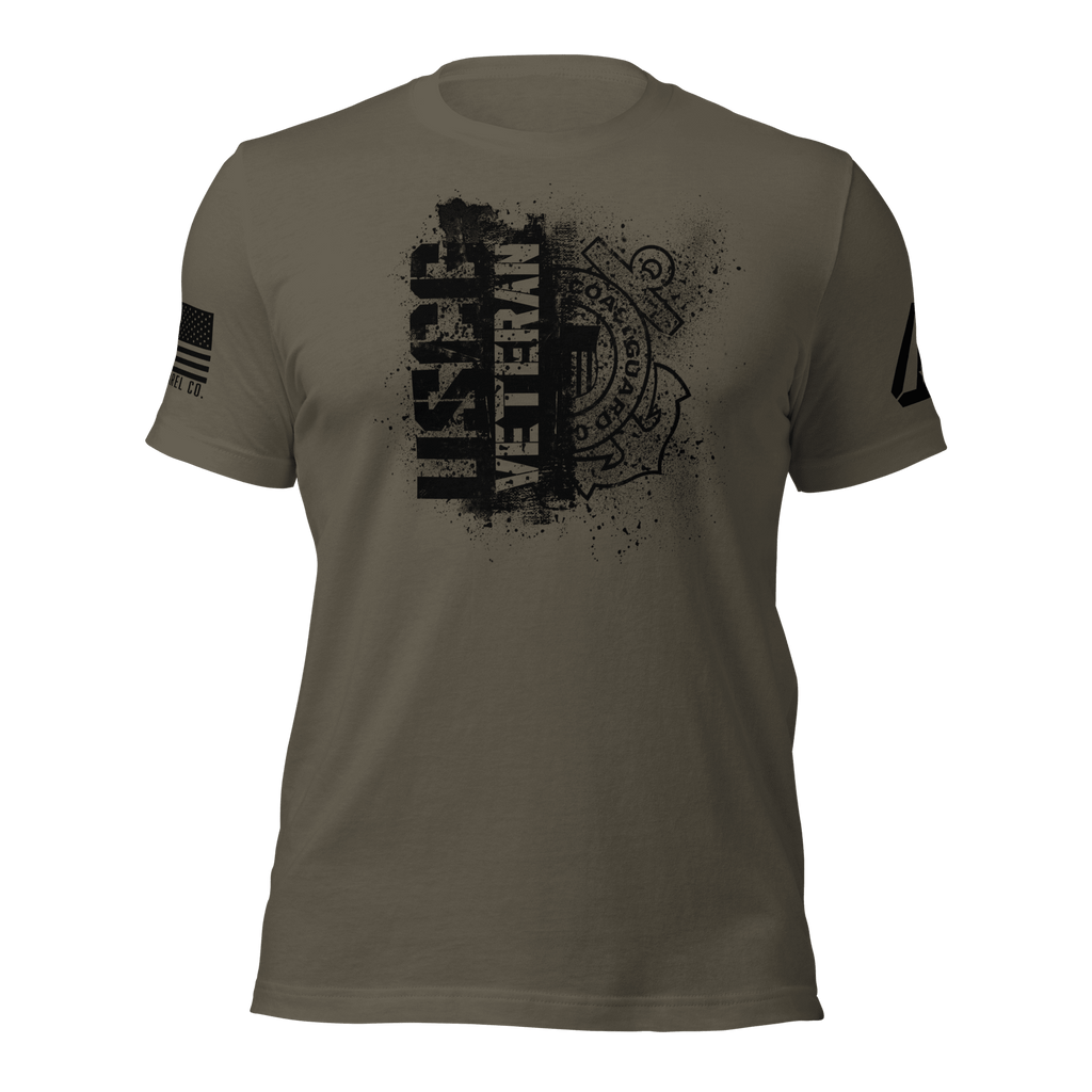 Army green t-shirt featuring a black "USCG VETERAN" chest graphic, an American flag, and a DIA logo on the sleeves.