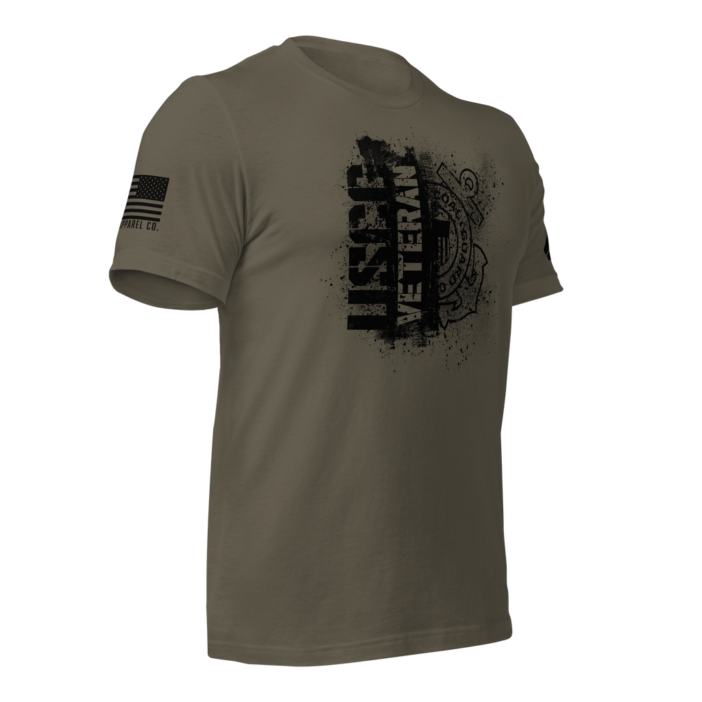 Army green t-shirt, angled left, featuring a black "USCG VETERAN" chest graphic and an American flag on the sleeve.