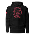 Black hoodie featuring red "STAY FERAL" snarling raccoon graphic and American flag sleeve patch.