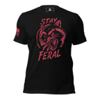 Black t-shirt with distressed red "Stay Feral" snarling raccoon graphic and an American flag patch on right sleeve.