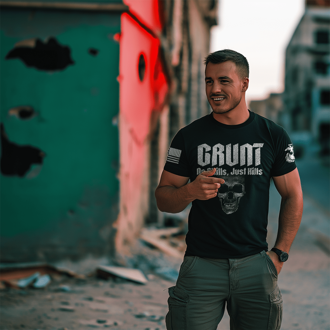 Man standing in an urban setting wearing a black "GRUNT" t-shirt with a skull and "No Skills, Just Kills" graphic.