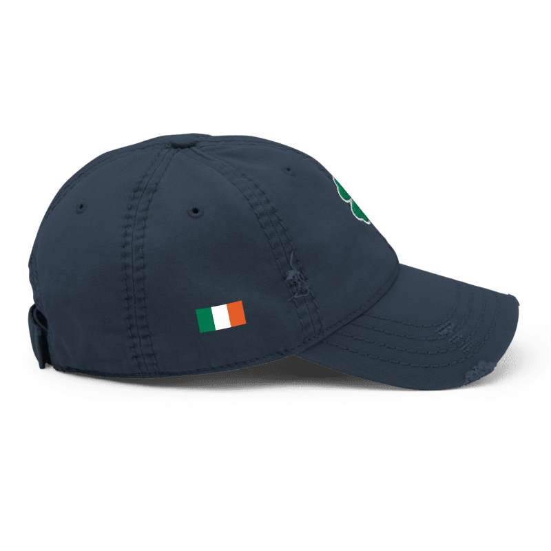 Navy blue distressed cap, shown from a right-side view, featuring an Irish flag and a green shamrock on the front.