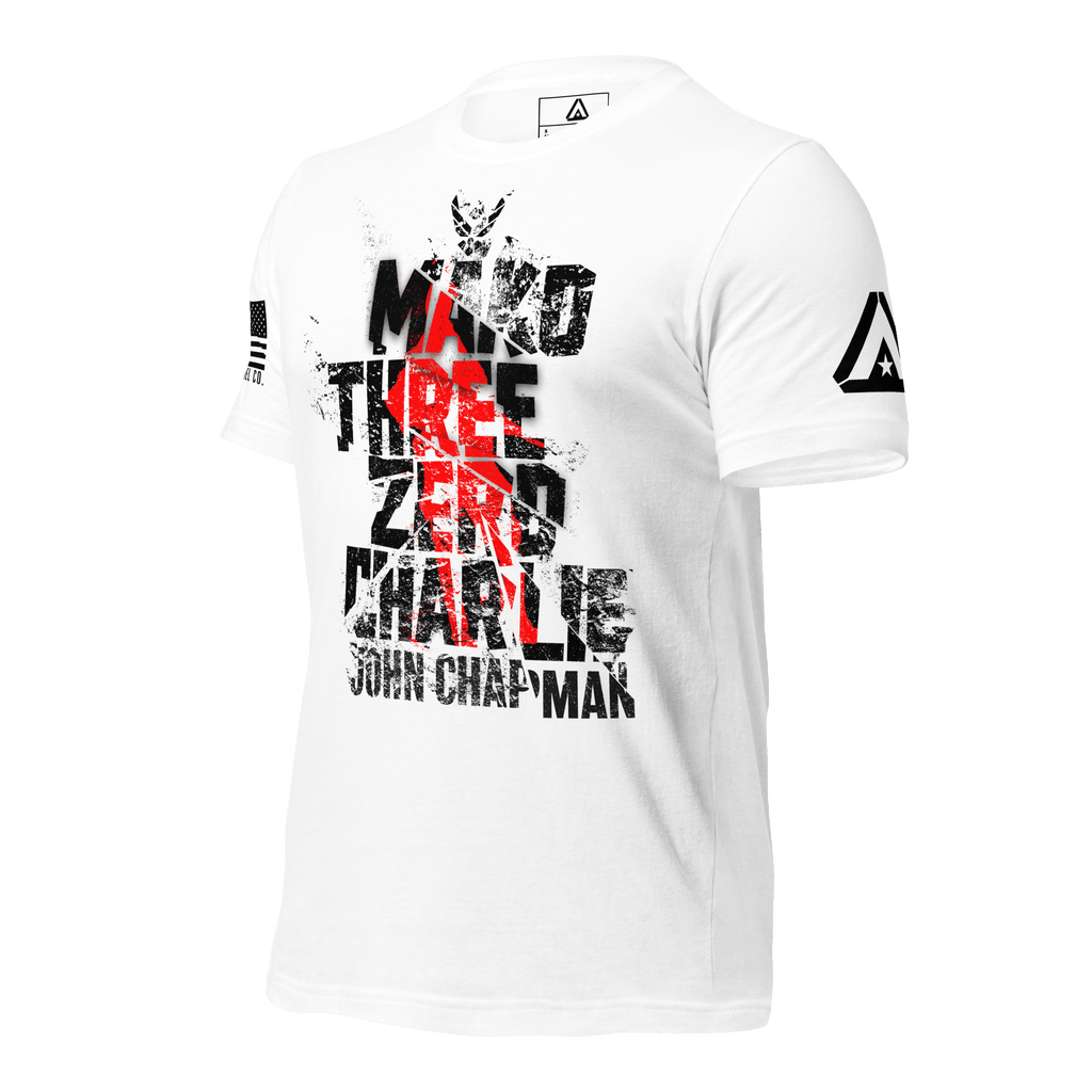 White t-shirt angled left, featuring distressed "Mako Three Zero Charlie John Chapman" text with DIA logo on the sleeve.