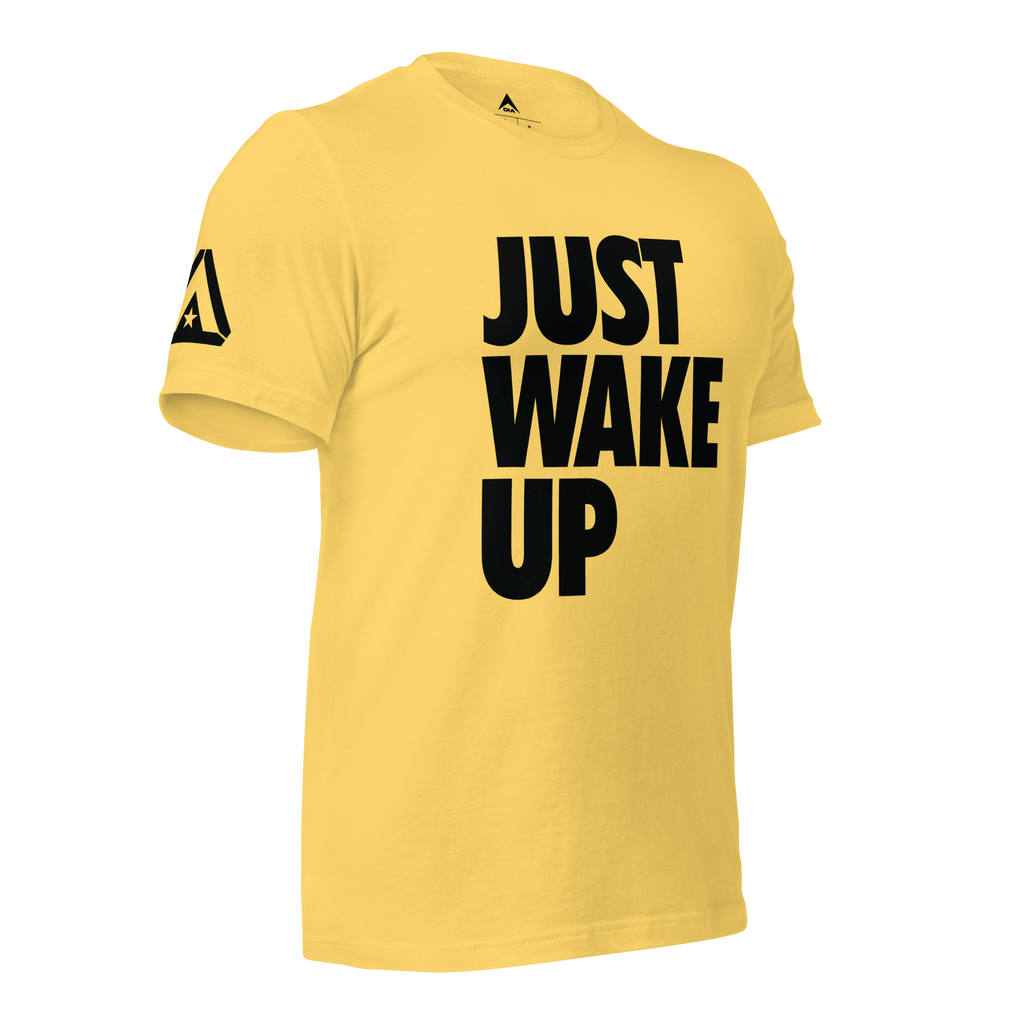 Yellow t-shirt, three-quarter view angled to the left, featuring "JUST WAKE UP" text and a DIA logo.