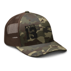Brown/Camo Abbey Gate Trucker Hat angled left showing camouflage pattern and crown detail