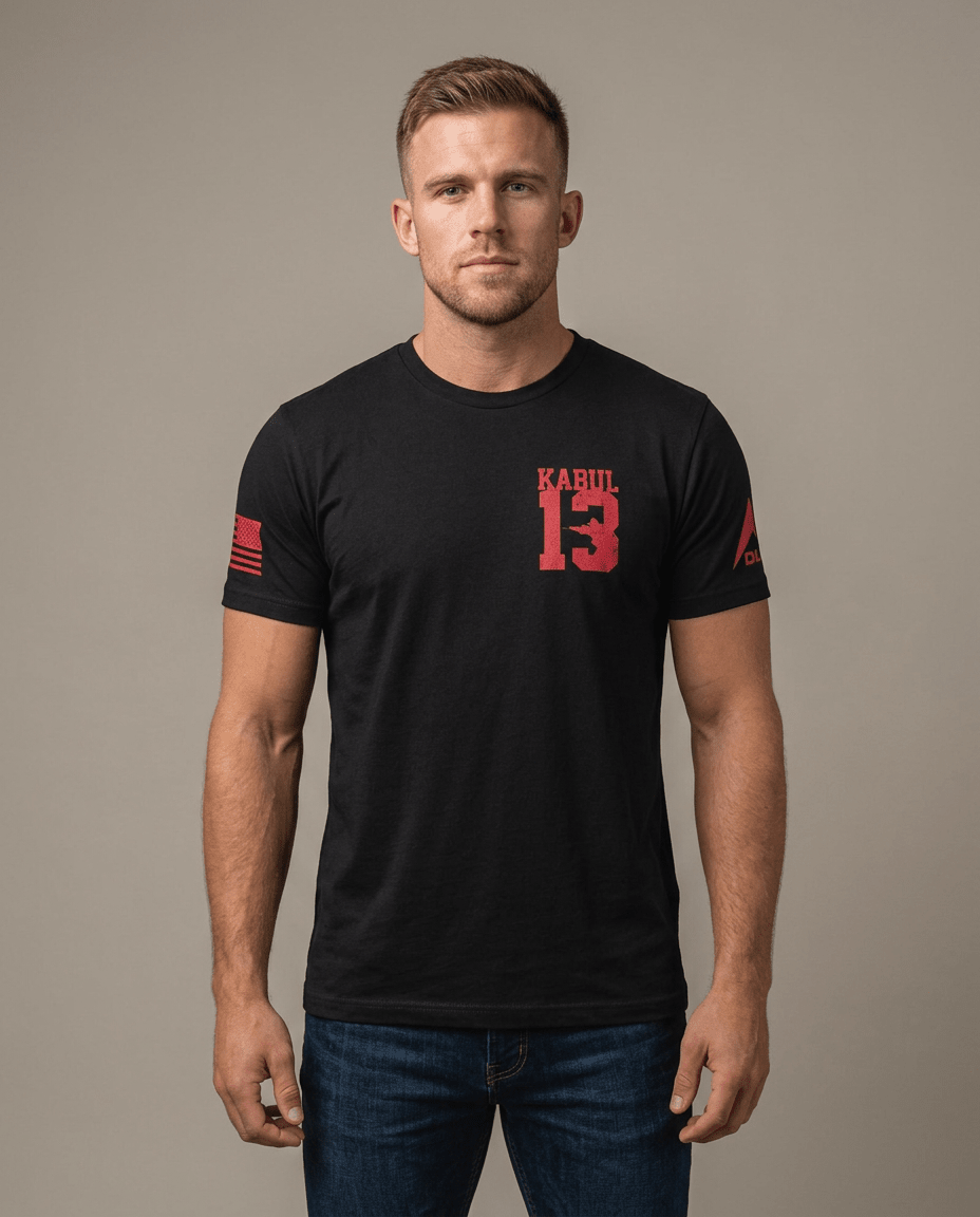 Man in studio wearing black t-shirt with a red "Kabul 13" chest logo, an American flag patch, and a DIA logo on the sleeve.