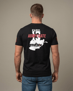 Man facing away in studio wearing black t-shirt with back graphic reading "Kabul 13 Abbey Gate" over Afghanistan map.