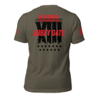 Army green t-shirt back view featuring a black "XIII" with barbed wire, red text, and a red American flag on the sleeve.
