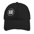 Black distressed ball cap with a white "KXIII" logo surrounded by stars.