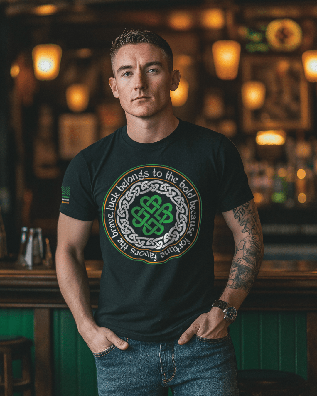 Man in a pub wearing a black Celtic knot t-shirt with "Luck belongs to the bold" text.