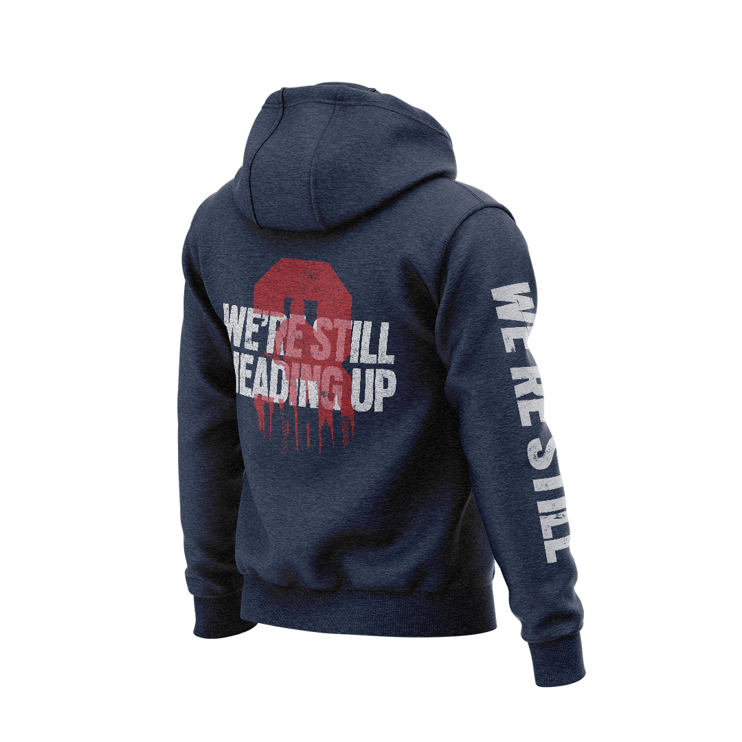 Navy hoodie angled left, back view featuring a red "3" with white "WE'RE STILL HEADING UP" and a skyline graphic.