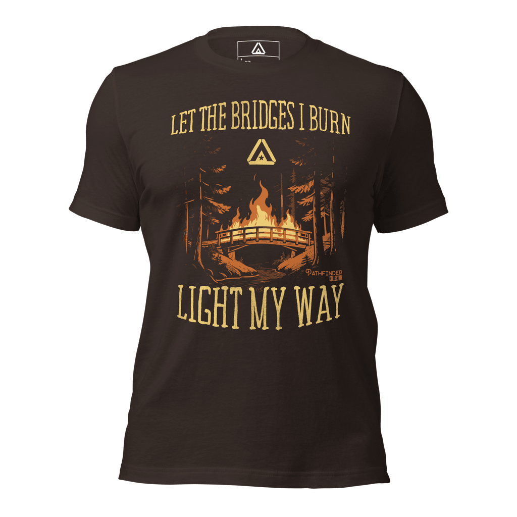 brown t-shirt, front view, featuring a burning bridge graphic and the text "LET THE BRIDGES I BURN LIGHT MY WAY".