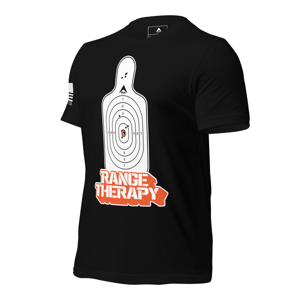 Black t-shirt angled left with a white target graphic, orange "RANGE THERAPY" text, and a white sleeve flag.