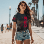 Woman at a beach wearing denim shorts and a charcoal RED Air Force edition DIA shirt.
