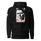 Black hoodie featuring a Ronald Reagan portrait graphic with "GREAT" text and an American flag sleeve patch.