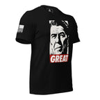Black T-shirt angled right, featuring a Ronald Reagan graphic with "GREAT" text and an American flag sleeve patch.