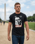 Man walking near the Washington Monument wearing a black T-shirt with a Ronald Reagan "GREAT" graphic.