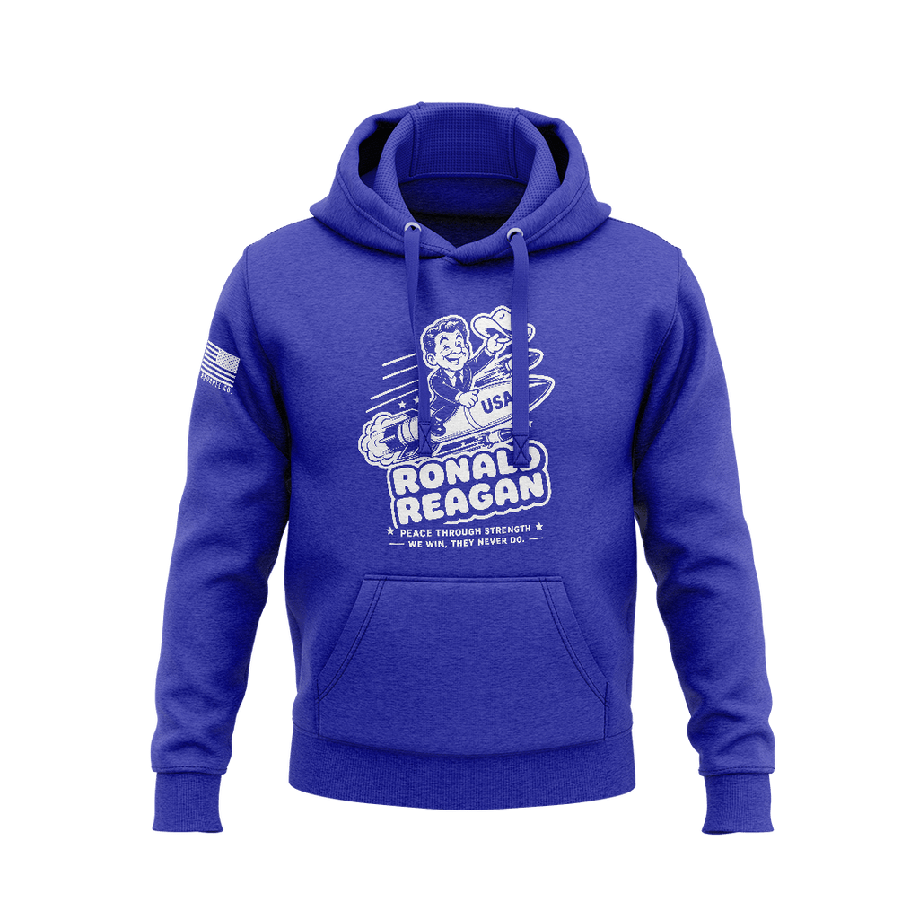 Blue hoodie featuring a cartoon Ronald Reagan riding a missile graphic with "PEACE THROUGH STRENGTH" text and an American flag sleeve patch.