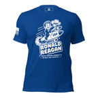 Blue t-shirt featuring cartoon Ronald Reagan on a missile graphic and American flag on the sleeve.