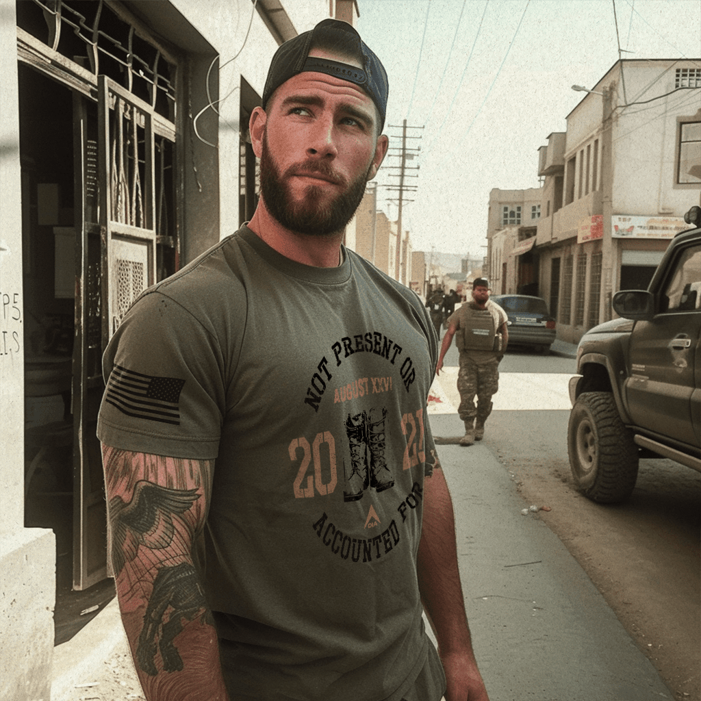 Man in a beard, dusty urban street with a tan SUV, wearing an army green t-shirt, angled left, featuring a DIA logo.