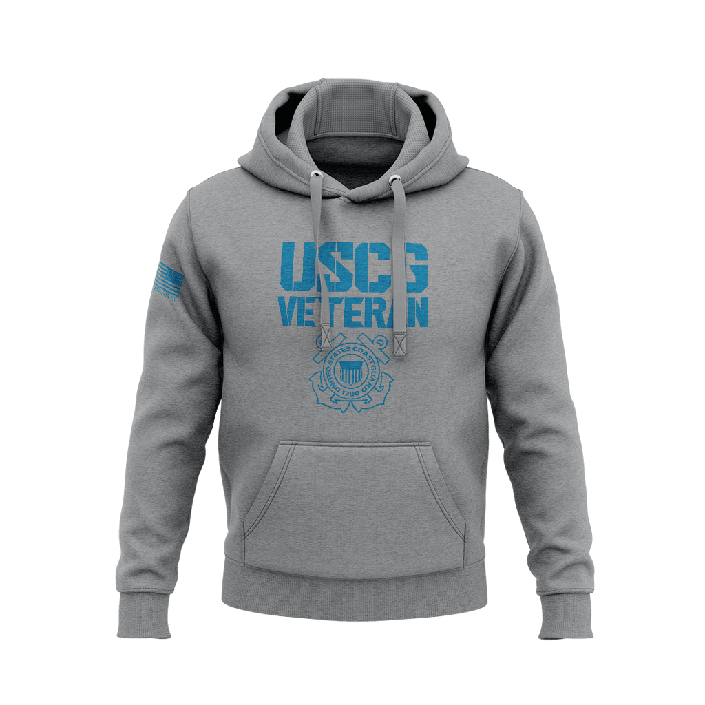 Heather gray hoodie displaying blue "USCG VETERAN" stencil font above Coast Guard seal, with right sleeve flag patch.   