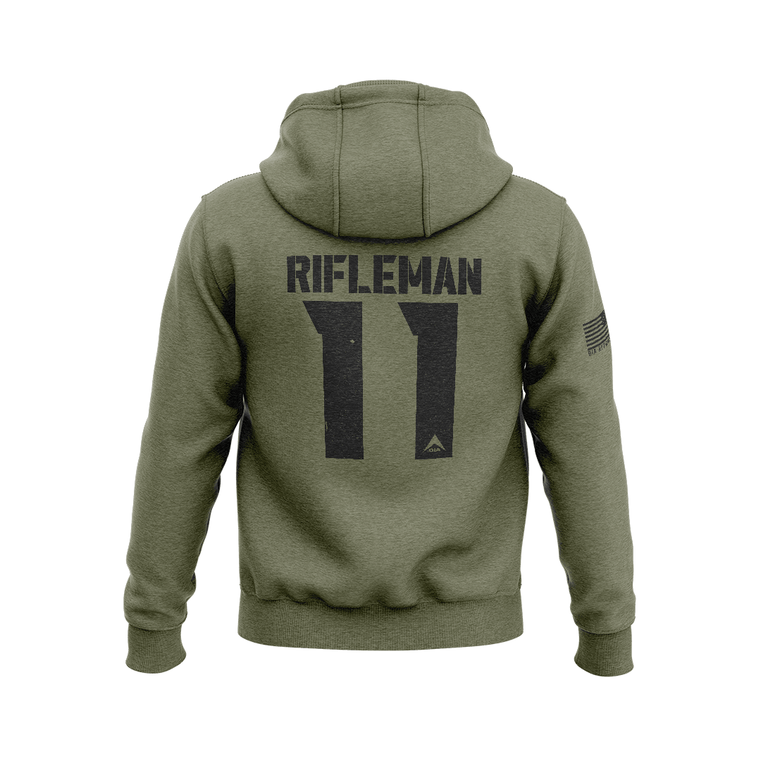 Army green hoodie, back view, featuring black RIFLEMAN 11 graphic, DIA logo, and American flag on the sleeve.