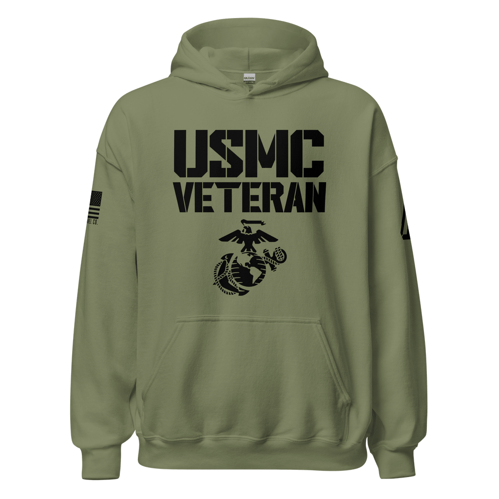 Olive green hoodie, front view, with black "USMC VETERAN" text, military emblem, and an American flag design on the sleeve.