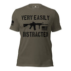 Front-facing army green shirt featuring a black "VERY EASILY DISTRACTED" rifle graphic and a black American flag.