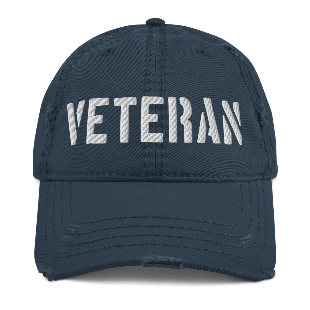 Navy blue distressed ball cap featuring "VETERAN" embroidered in white bold letters across the front crown.