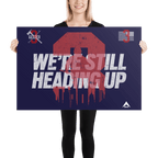 A smiling woman in black holds a navy "3 Truck" poster with white "WE'RE STILL HEADING UP" text and a red graphic.